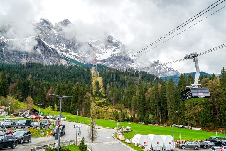 Bavaria, Germany - August 21, 2023 : Summer view of the Zugspitze cable car from the Lake Eibsee station to the Zugspitze, the highest mountain top in Germany in the Bavarian Alps region.