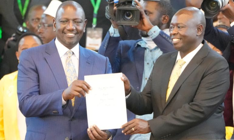 William Ruto, and his deputy Rigathi Gachagwa, show the certificate after the announcement in the presidential race at the Centre in Bomas, Nairobi, Kenya, Monday, Aug.15, 2022.. Kenya's election commission announced Monday that William Ruto, has won with 50.49 percent of the vote, and called the vote
