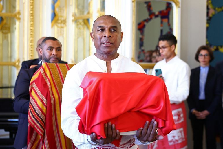 Malagasy officials hold boxes containing the three skulls during a ceremony to mark the return of three Sakalava skulls, those of two warriors and one believed to be that of slain Malagasy king Toera, taken by French troops during the colonisation of Madagascar in the late 19th century, at the Culture Ministry in Paris, France, August 26, 2025. REUTERS/Abdul Saboor
