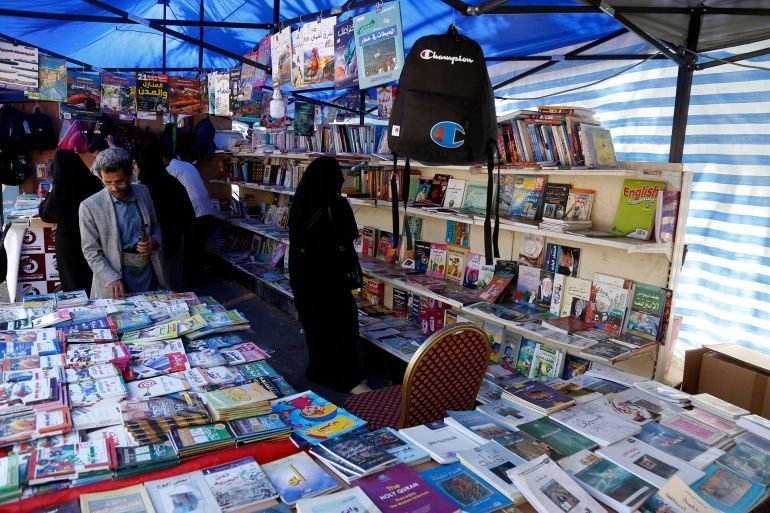 SANA'A, YEMEN - SEPTEMBER 26: Yemenis visit the book fair opened as an opportunity to enable people to buy books with reduced prices during the continued economic crisis, on September 26, 2021 in Sana'a, Yemen. Book Fair in Sana'a is in dire straits owing to a lack of customers during the six days it has been because of the severe economic crisis of people following the nearly seven years of war and blockade that left 80% of the country's 28-million population in need of assistance and pushed most of them only to focus on how they can feed their children. Only a handful of visitors came to the fair and most of them did not even buy books but left after only reading the books while standing beside its shelves. Despite the fair opening that was planned to enable reading enthusiasts and university students who were affected by the continued crisis greatly, to be able to buy books they need at discount prices, but it seems that most Yemenis look on basic daily needs like food and water more than anything else. (Photo by Mohammed Hamoud/Getty Images)