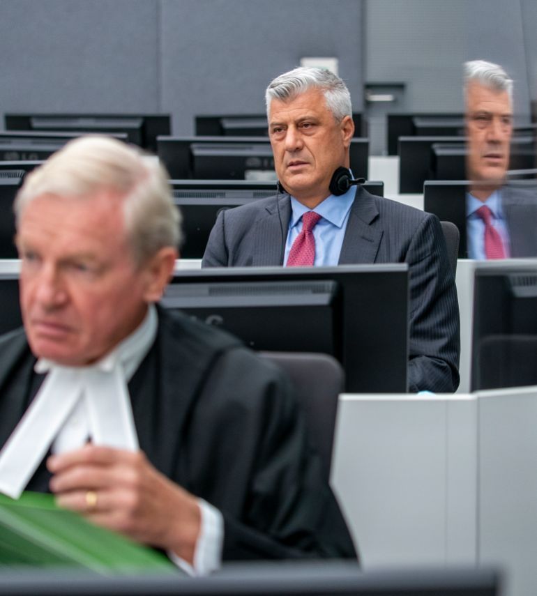 Hashim Thaci, right, who resigned as Kosovo's president to face charges including murder, torture and persecution, and his attorney David Hooper, left, make their first courtroom appearance before a judge at the Kosovo Specialist Chambers court in The Hague, Netherlands, Monday, Nov. 9, 2020. An international prosecutor has indicted Thaci on 10 charges of crimes against humanity and war crimes for his leadership of fighters with the Kosovo Liberation Army who are accused of illegally imprisoning, abusing and murdering captured opponents and perceived traitors during the war. (Jerry Lampen via AP Photo, Pool)