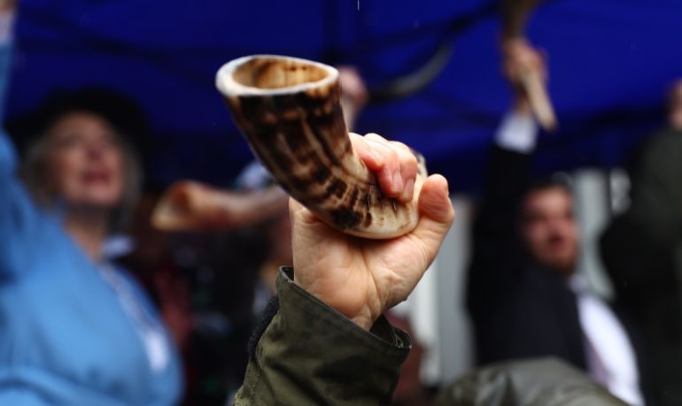 LONDON, ENGLAND - MARCH 10: A participant holds aloft his Shofar horn following The Blow For Hostages event at St John's Synagogue, on March 10, 2024 in London, England. With the war on Gaza entering its sixth month and Israeli hostages taken by Hamas still being held, (Photo by Peter Nicholls/Getty Images)