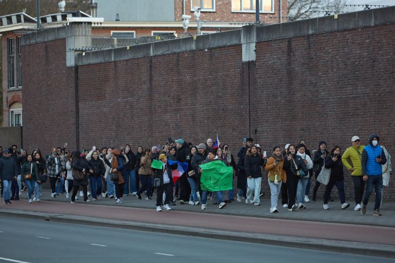 THE HAGUE, NETHERLANDS - MARCH 12: Supporters of ex-leader of the Philippines Rodrigo Duterte living in The Netherlands and Belgium gather outside The Hague Penitentiary Institution, which includes a special independently operating unit at its Scheveningen location and houses the United Nations Detention Unit (UNDU), a UN-administered facility within the prison, on March 12, 2025 in The Hague, Netherlands. Former Philippine President Rodrigo Duterte was arrested this week in Manila on an International Criminal Court (ICC) warrant for crimes against humanity linked to thousands of deaths over his brutal anti-drug campaign. He is expected to be detained in the Hague, where the ICC is based. (Photo by Pierre Crom/Getty Images)