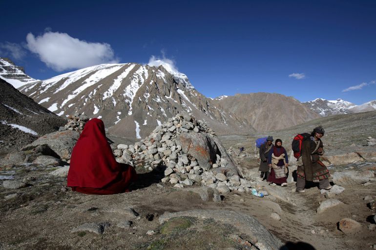 PURANG COUNTY, CHINA - JUNE 16: (CHINA OUT) A nun from Nepal worships the snow-capped Kangrinboqe Mountain, known as Mt. Kailash in the West, June 16, 2007 in Purang County of Tibet Autonomous Region, China. Kangrinboqe, meaning