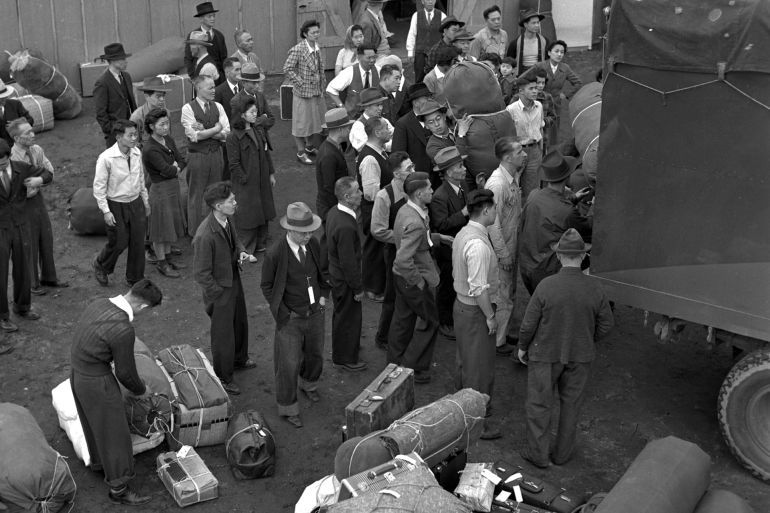 People of Japanese descent, relocated from the Seattle area, unload their belongings as they arrive at an internment camp in Puyallup, Wash., in April, 1942. They were among thousands of people forced from their homes in the name of national security following the attack on Pearl Harbor. (AP Photo/Paul Wagner)