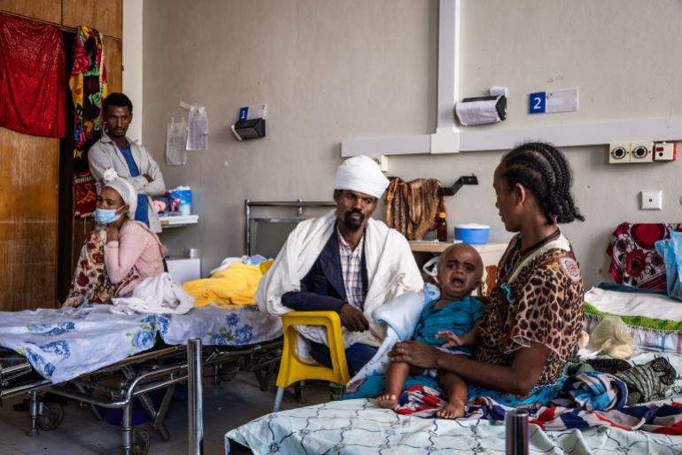 MEKELLE, ETHIOPIA - FEBRUARY 16: Tsige Nerae (R), 47, sits with her husband (C) and son Selam Gebremikael, 1, who is suffering from hydrocephalus caused by maternal malnutrition according to the doctors in Ayder Hospital in the city of Mekelle on February 16, 2024 in Tigray Region, Ethiopia. More than 20 million Ethiopians are in need of food aid, according to estimates from the UN's Office for the Coordination of Humanitarian Affairs (UNOCHA). The situation is particularly acute in drought-stricken Tigray, in the country's north, which is still recovering from a two-year war between the Ethiopian government and allied forces on one side, and Tigrayan forces on the other, during which the region's economy was devastated and many were displaced. The combined effects of war and drought have raised the specter of famine, which the federal government in Addis Ababa denies is imminent, saying it is committed to providing aid. (Photo by Ed Ram/Getty Images)