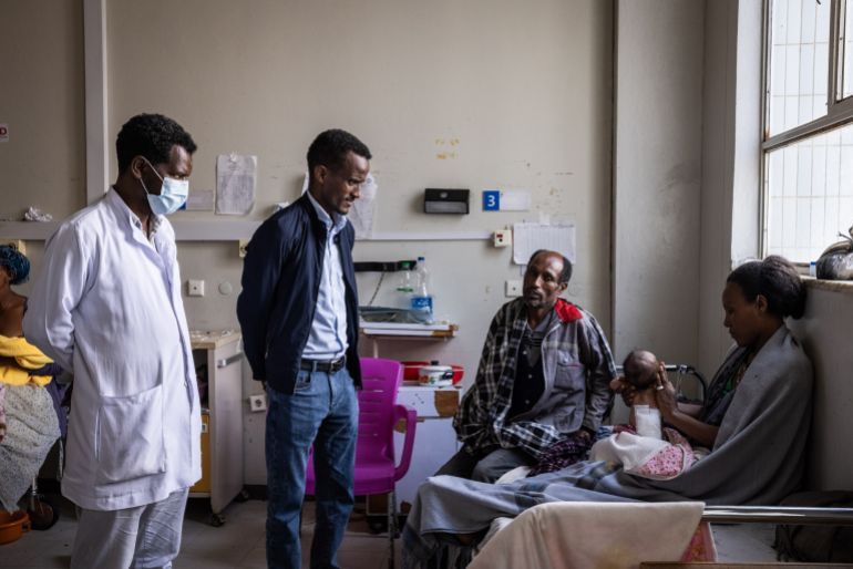 MEKELLE, ETHIOPIA - FEBRUARY 16: Dr Hailemariam Gebrearegay speaks to Mehari Tesfay, 40, his wife and their son Daniel Mehari who has had an operation to treat a spinal condition caused by maternal malnutrition in Ayder Hospital in the city of Mekelle on February 16, 2024 in Tigray Region, Ethiopia. More than 20 million Ethiopians are in need of food aid, according to estimates from the UN's Office for the Coordination of Humanitarian Affairs (UNOCHA). The situation is particularly acute in drought-stricken Tigray, in the country's north, which is still recovering from a two-year war between the Ethiopian government and allied forces on one side, and Tigrayan forces on the other, during which the region's economy was devastated and many were displaced. The combined effects of war and drought have raised the specter of famine, which the federal government in Addis Ababa denies is imminent, saying it is committed to providing aid. (Photo by Ed Ram/Getty Images)
