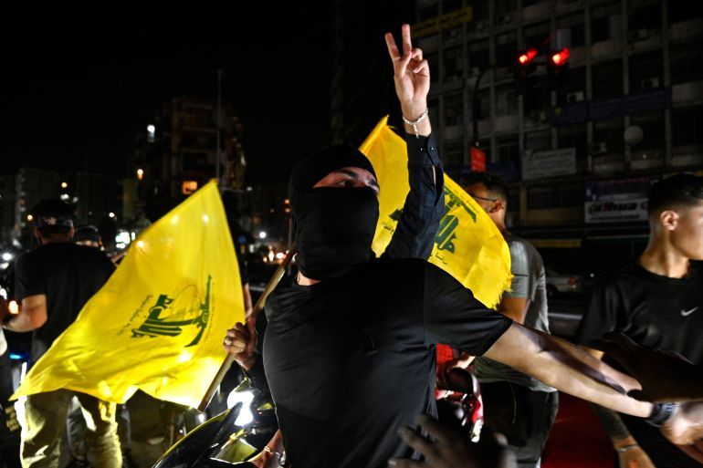 epa12355393 Supporters fly Hezbollah flags as they rally to protest against the Lebanese government's endorsement of a plan to disarm the militant group, in a southern suburb of Beirut, Lebanon, 05 September 2025. The Lebanese government endorsed the army's plan to disarm Hezbollah in a cabinet meeting on 05 September. EPA/WAEL HAMZEH
