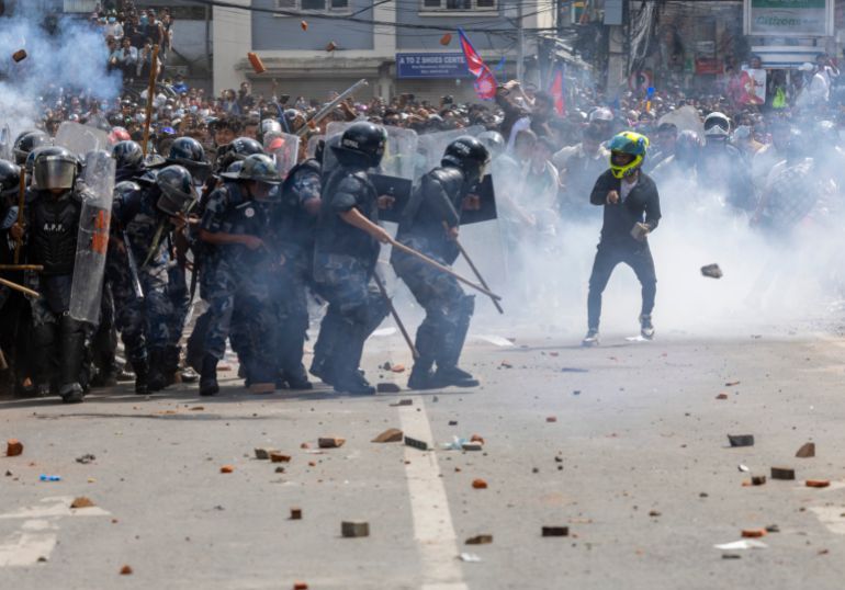 epa12362230 Protesters clash with police in front of the parliament building in Kathmandu, Nepal, 08 September 2025. Young demonstrators gathered in the capital to demand an end to corruption and the lifting of social media bans. The government shut down 26 platforms, including Facebook, YouTube, Instagram, and WhatsApp, after they refused to register in Nepal. At least six people were killed and dozens were injured during the protest. EPA/NARENDRA SHRESTHA