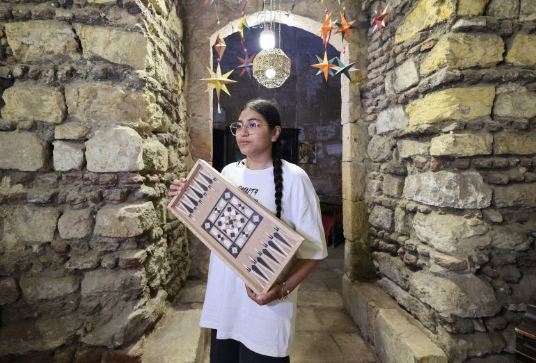 Hagar Ayman,15, an Egyptian student shows her wooden craft at Egypt’s 
