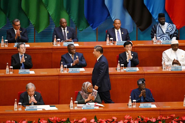 China’s President Xi Jinping is applauded as he walks to the podium to speak at the opening ceremony of the Forum on China-Africa Cooperation (FOCAC) in Beijing’s Great Hall of the People on September 5, 2024. (Photo by GREG BAKER / POOL / AFP)