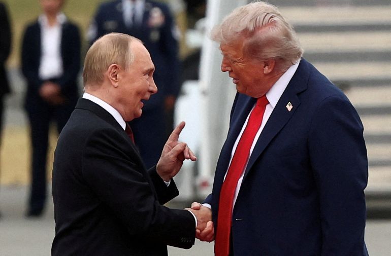 FILE PHOTO: U.S. President Donald Trump shakes hand with Russian President Vladimir Putin, as they meet to negotiate for an end to the war in Ukraine, at Joint Base Elmendorf-Richardson in Anchorage, Alaska, U.S., August 15, 2025. REUTERS/Kevin Lamarque/File Photo