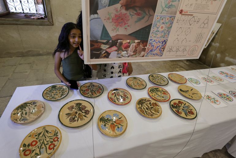 Egyptian children look at some products of handmade craft at Egypt’s 
