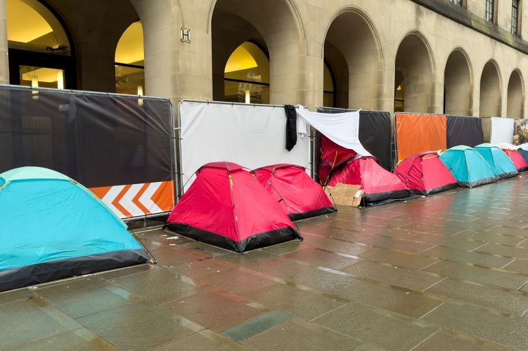 Homeless tentsduring a cold and wet morning in St Peter's Square in Manchester