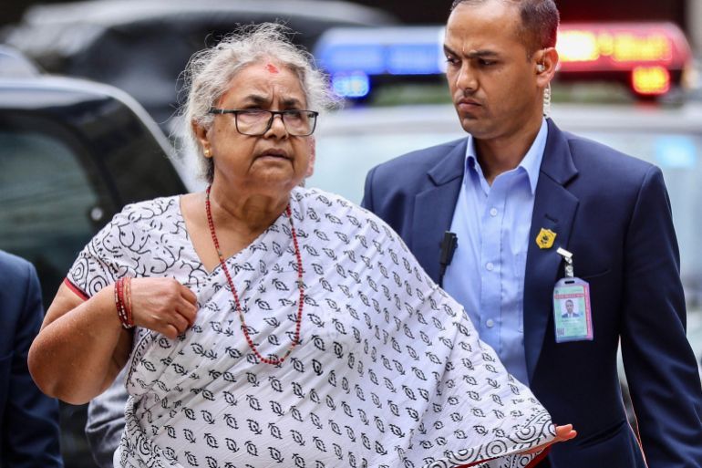 Newly-elected Prime Minister of Nepal’s interim government Sushila Karki (L) arrives at the Civil Service Hospital to visit victims injured during clashes with security personnel, in Kathmandu on September 13, 2025.