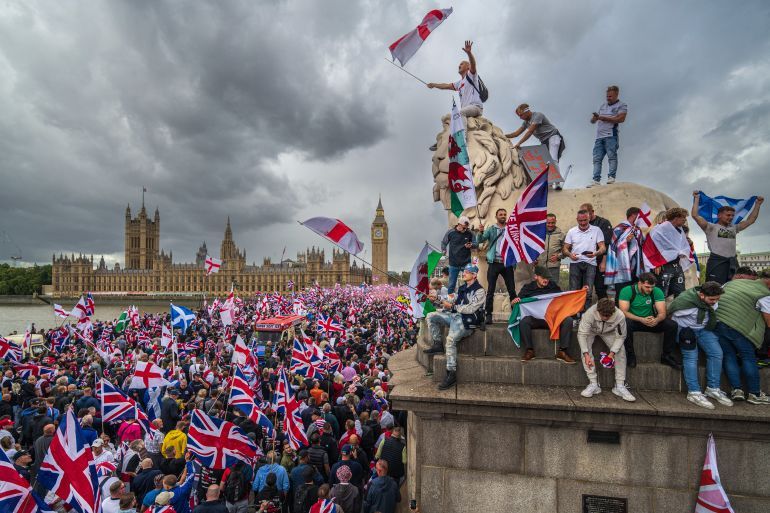 LONDON, ENGLAND - SEPTEMBER 13: Protesters wave Union Jack and St George's England flags during the