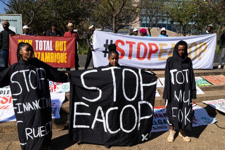 epa12309725 Environmental protesters gather outside the head offices of Standard Bank as they protest against the actions of Total Energies in Africa, in Johannesburg, South Africa, 19 August 2025. The protesters gathered to hand a memorandum to TotalEnergies after marching from Standard Bank, claiming the French energy giant is involved in land grabs, displacement of local populations, and ecological devastation surrounding its energy involvement in Africa, including the East African Crude Oil Pipeline Project (EACOP). EPA/KIM LUDBROOK
