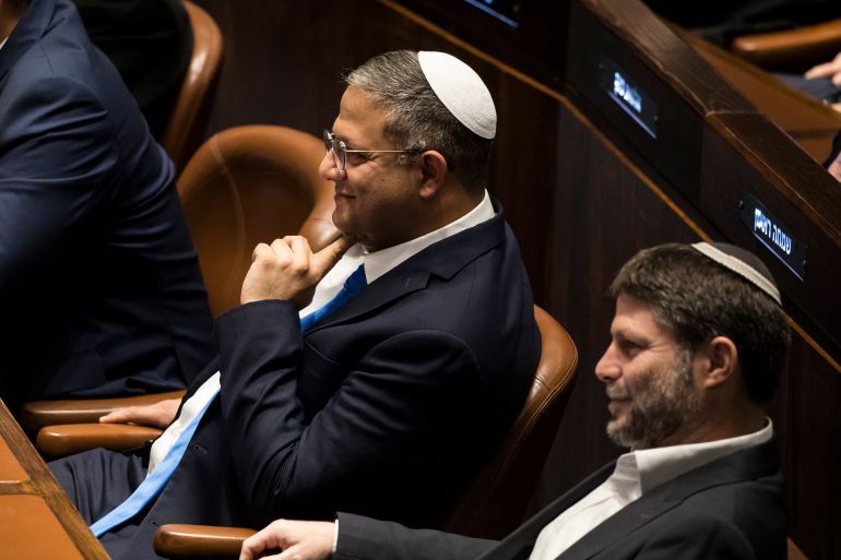 JERUSALEM, ISRAEL - DECEMBER 29: Designated Minister of National Security Itamar Ben Gvir (L) and designated Israeli Minister of Finance Bezalel Smotrich (R) react at the Israeli parliament during a new government sworn in discussion at the Israeli parliament on December 29, 2022 in Jerusalem, Israel. Conservative Benjamin Netanyahu and a bloc of nationalist and religious parties won a clear election victory last month and will be sworn in as government to the Knesset today. This completes Netenyahu's political comeback with a record sixth term in office. (Photo by Amir Levy/Getty Images)