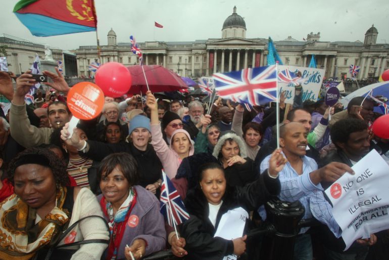 LONDON - MAY 07: Protestors cheer, wave flags and banners during a march hoping to draw attention to claims of exploitation and discrimination of migrant workers, in Trafalgar Square on May 7, 2007 in London. The march started after the Archbishop of Westminster celebrated a special Mass for Migrants at Westminster Cathedral. (Photo by Matt Cardy/Getty Images)