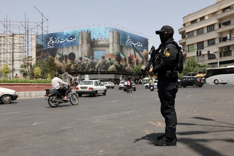 FILE PHOTO: A security guard stands on a street, during early hours of ceasefire, in Tehran, Iran, June 24, 2025. Majid Asgaripour/WANA (West Asia News Agency) via REUTERS ATTENTION EDITORS - THIS PICTURE WAS PROVIDED BY A THIRD PARTY/File Photo