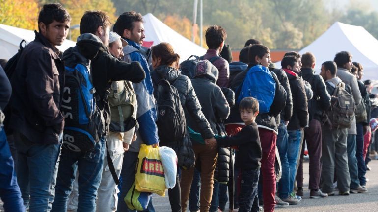 Refugees wait at a inspection station near the Austrian-German border near to Passau, Germany, 30 October 2015. An escalating row in Chancellor Angela Merkel's government over mass arrivals of migrants from war zones provoked a rebuke on 30 October 2015 from German deputy Chancellor Sigmar Gabriel, leader of Germany's Social Democratic Party (SPD). Merkel's September 5 decision to open Germany's borders and absorb migrants has won global praise but local recrimination. The ruling party of southern Bavaria state, the Christian Social Union (CSU), is pressing Merkel's Christian Democrats (CDU) to limit new arrivals. A key bone of contention is a CSU demand for