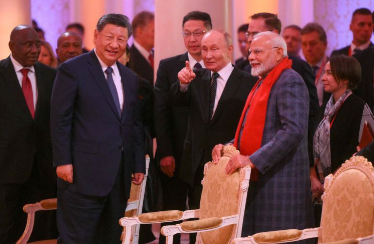 In this handout picture taken and released by Photo host brics-russia2024.ru on October 22, 2024, Chinese President Xi Jinping, Russia's President Vladimir Putin and Indian Prime Minister Narendra Modi attend a concert prior to an informal dinner on the sidelines of the BRICS summit in Kazan. (Photo by Alexander Kryazhev / Photo host brics-russia2024.ru / AFP) / RESTRICTED TO EDITORIAL USE - MANDATORY CREDIT