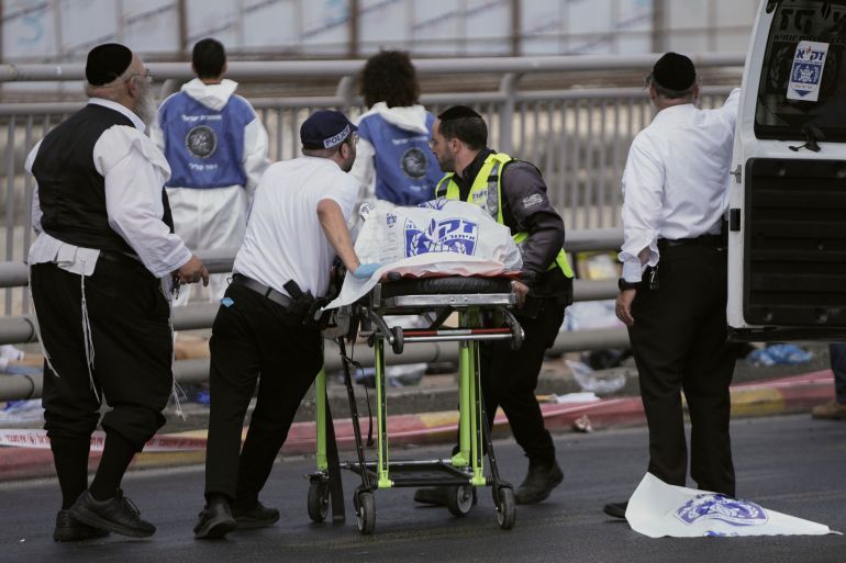 Israeli Zaka rescue and recovery team carry the body of a victim at the scene of shooting attack where several people killed and injured in Jerusalem, Monday, Sept. 8, 2025. (AP Photo/Mahmoud Illean)