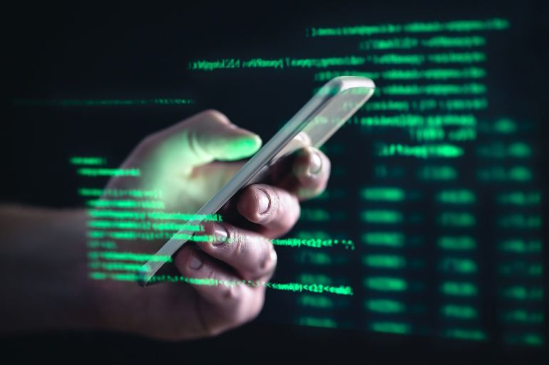 Darkweb, darknet and hacking concept. Hacker with cellphone. Man using dark web with smartphone. Mobile phone fraud, online scam and cyber security threat. Scammer using stolen cell. AR data code.