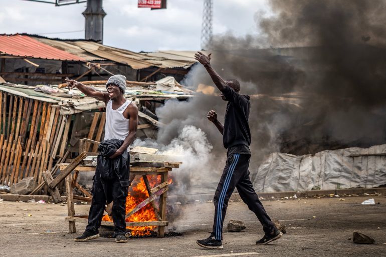 Protesters react as they chant anti-government slogans while confronting Kenya police officers during clashes at Saba Saba Day protests in Nairobi on July 7, 2025.