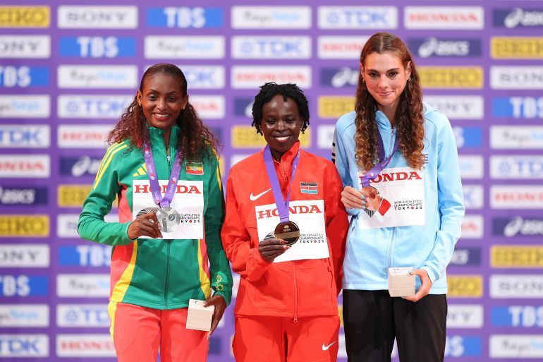 TOKYO, JAPAN - SEPTEMBER 14: (L-R) Silver medalist Tigst Assefa of Team Ethiopia, Gold medalist Peres Jepchirchir of Team Kenya and Bronze medalist Julia Paternain of Team Uruguay pose for a photo on the podium during the Women's Marathon medal ceremony on day two of the World Athletics Championships Tokyo 2025 at National Stadium on September 14, 2025 in Tokyo, Japan. (Photo by Emilee Chinn/Getty Images)