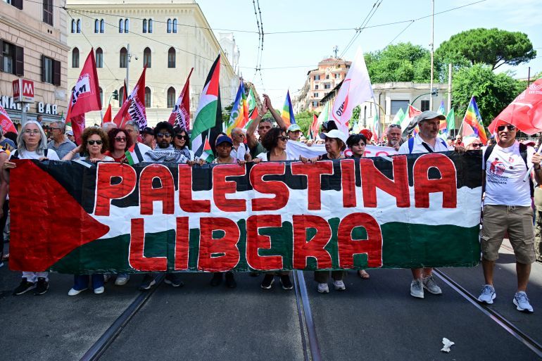 Protestors hold a banner reading