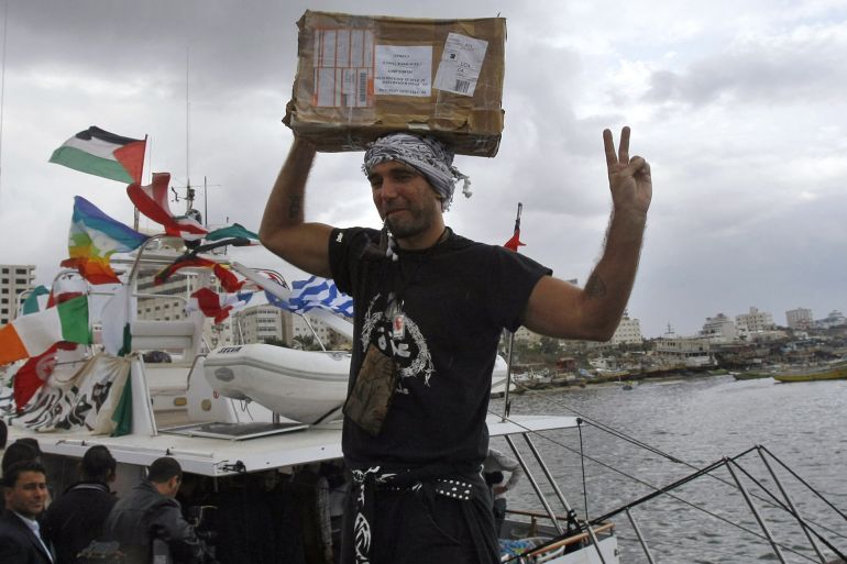Italian peace activist Vittorio Arrigoni holds up a box of medicine as he celebrates the arrival of 20-metre (65-foot) ship